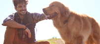 man petting dog