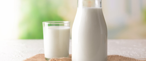 A glass and jug of milk