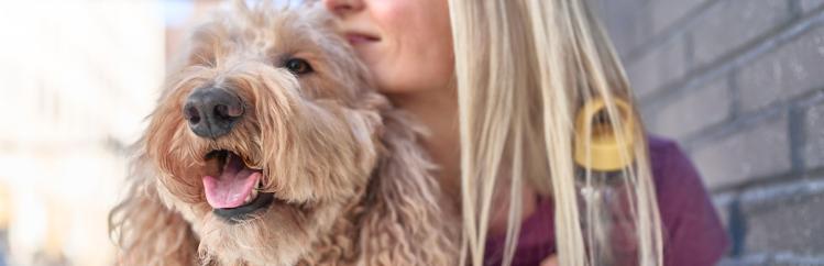 A woman holding a dog