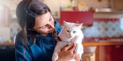 woman holding a white cat