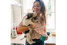 Woman is holding her dog