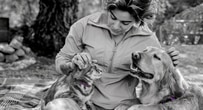 Woman petting a cat and a dog